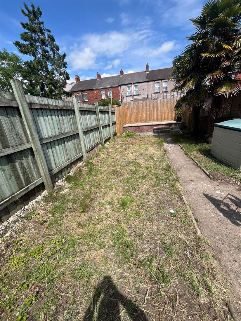 A Cardiff back garden cleared of rubbish bags and left tidy